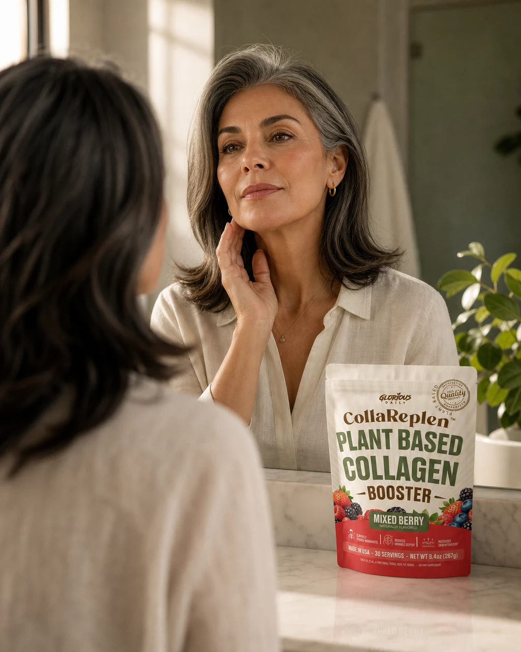 Woman studying her jawline in the bathroom mirror, CollaReplen pouch on the counter